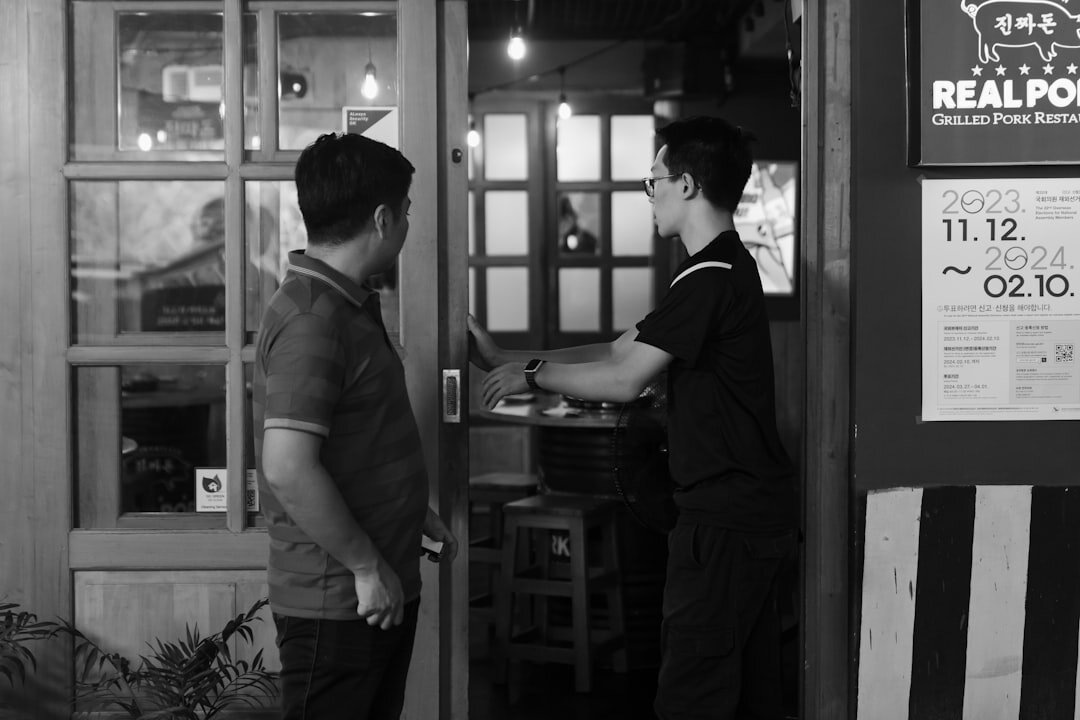 A man opens the door for a customer.