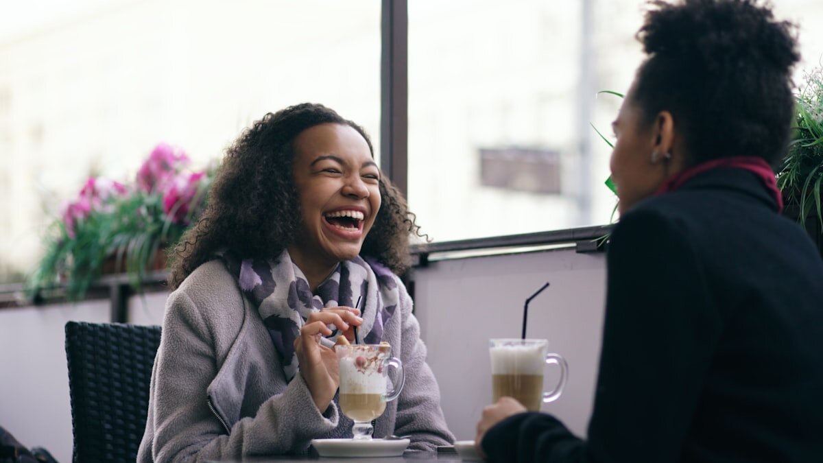 Regular customers chatting over coffee in a cafe