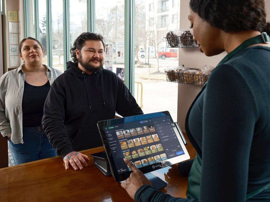 Customers ordering at a counter with a tablet