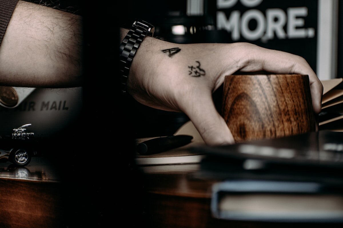 Hands holding a takeaway coffee cup in a cafe