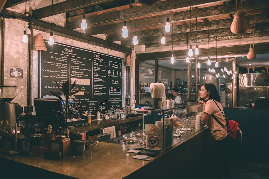 a woman standing at a counter in a restaurant